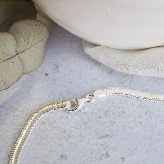 Sterling Silver 4mm Snake Necklace - Timeless Sophistication and Effortless Style. This stunning piece is crafted with exquisite detail, showcasing a sleek and elegant design that will elevate any outfit.