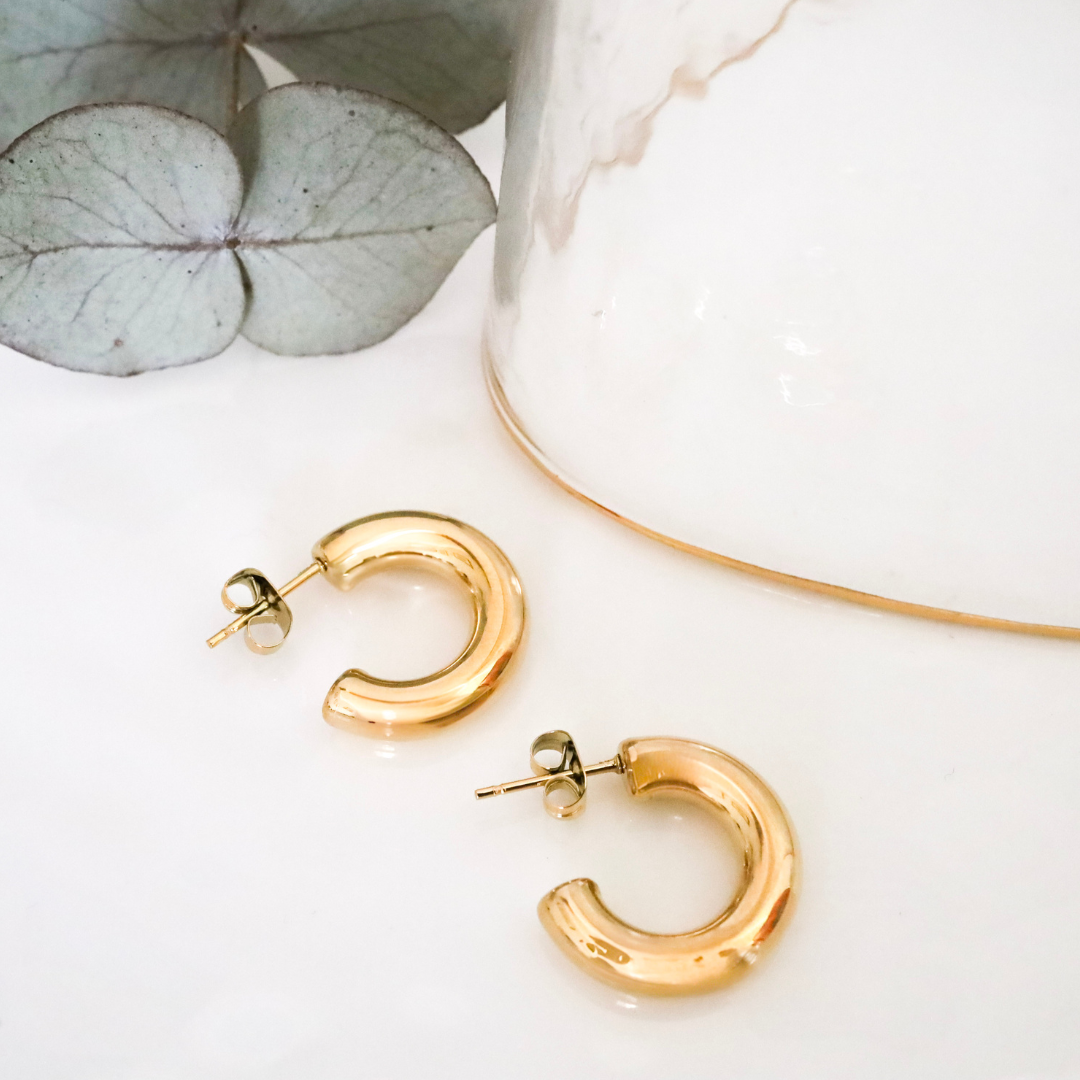 18ct Gold Plated Surgical Steel Bold Small Hoop Earrings - Understated Luxury for Everyday Wear. These exquisite earrings are expertly crafted from high-quality surgical steel and plated with a thick layer of 18ct gold.