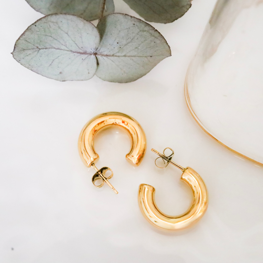 18ct Gold Plated Surgical Steel Bold Small Hoop Earrings - Understated Luxury for Everyday Wear. These exquisite earrings are expertly crafted from high-quality surgical steel and plated with a thick layer of 18ct gold.