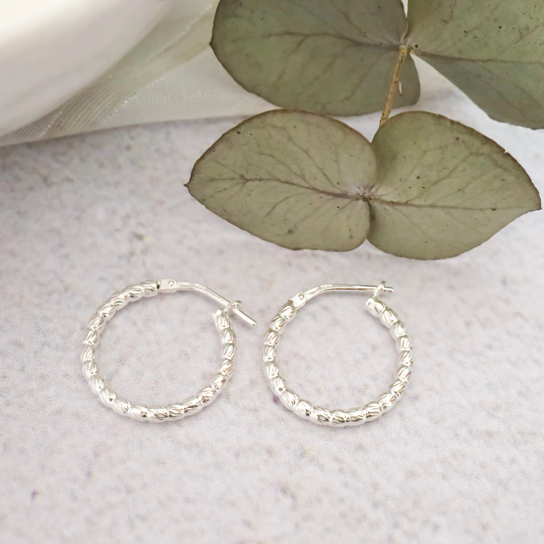 Sterling Silver Hoop with Detail - Intricate detailing expertly crafted from the finest sterling silver, adding a touch of elegant sophistication to any outfit.