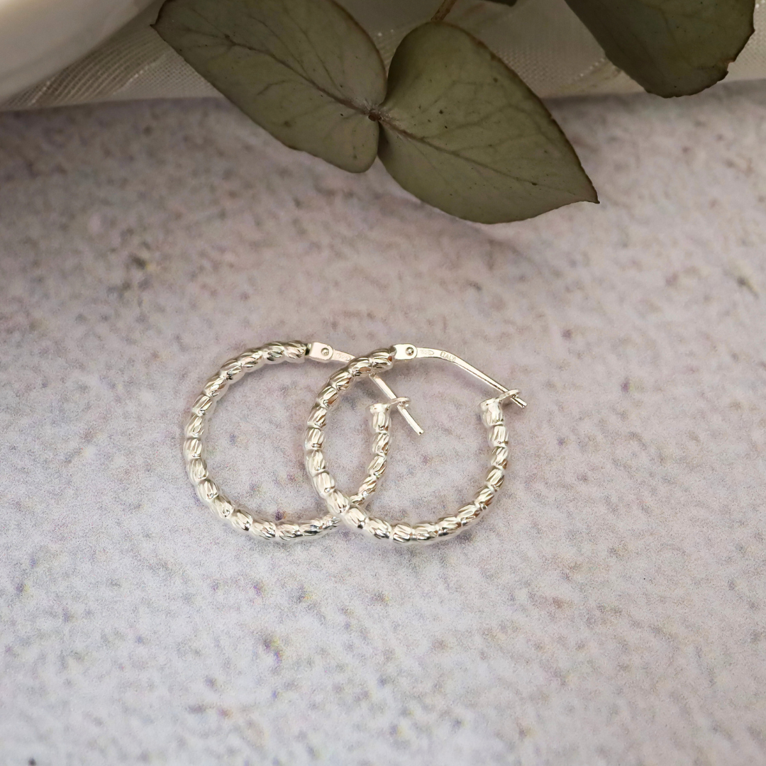 Sterling Silver Hoop with Detail - Intricate detailing expertly crafted from the finest sterling silver, adding a touch of elegant sophistication to any outfit.