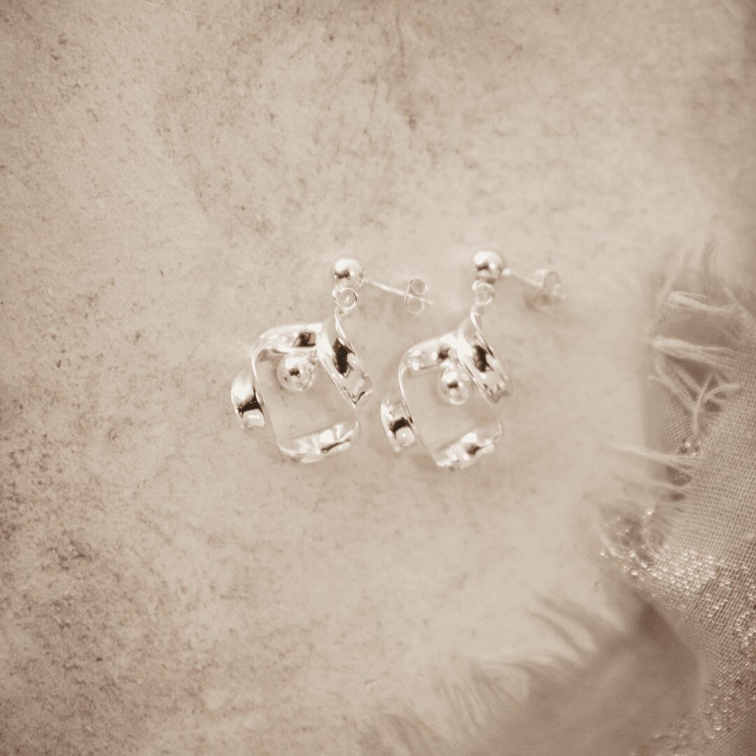 Elegant 925 sterling silver earrings featuring a unique twisted design with a polished ball detail, perfect for a modern and sophisticated look.